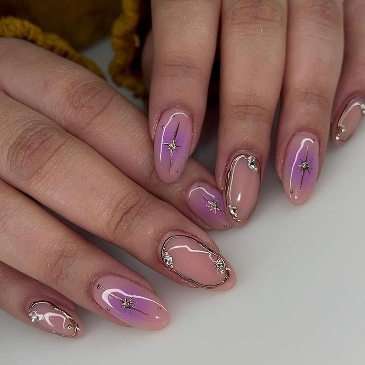 Glamorous Gradient Nail Design with Star Accents and Gold Detailing