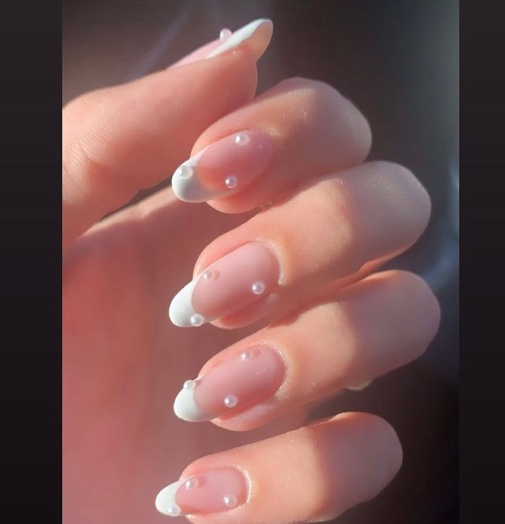 Chic Soft Pink French Tip Nails with Elegant Pearl Accents.