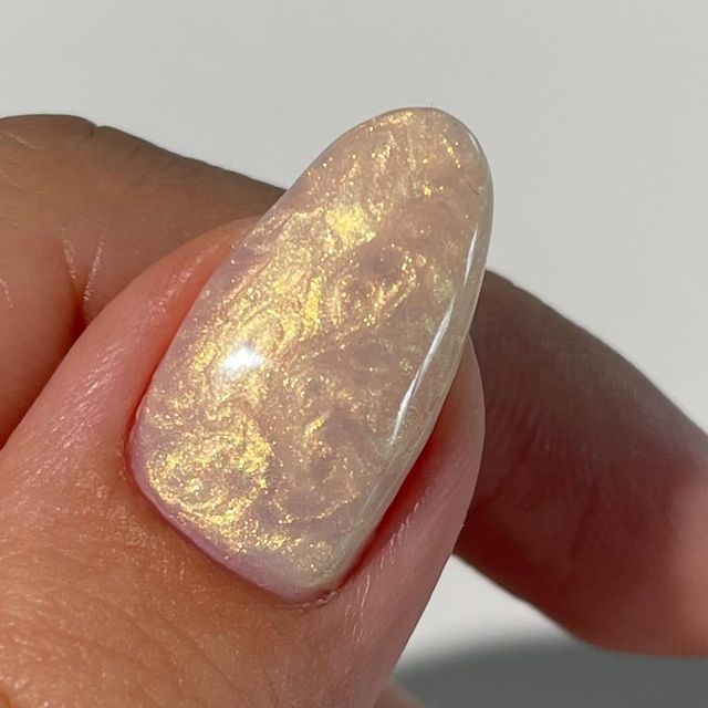 Iridescent Nail Design with Captivating Swirl Patterns for Elegant Manicures.