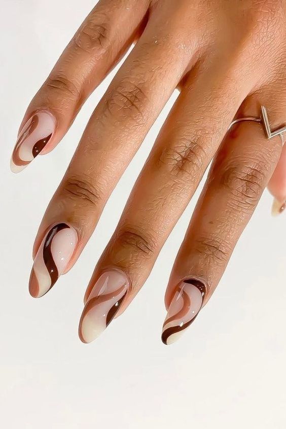 Elegant Nail Design: Warm Neutral Tones with Artistic Swirling Patterns