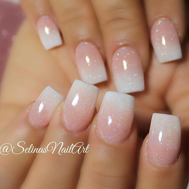 Elegant Ombre Nail Design with Soft Pink, White Hues, and Glitter Accents