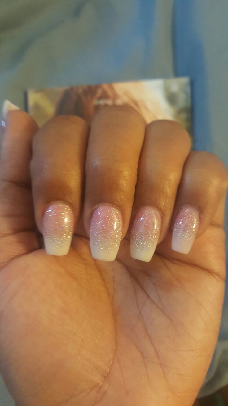 Elegant Ombre Nails: Subtle Pink and White with Glitter Accents for a Feminine Touch.