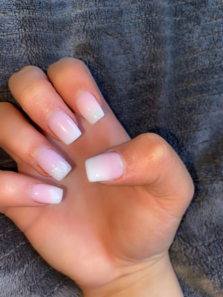 Chic Ombre Nails: A Sophisticated Blend of Soft Pink and White with a Touch of Sparkle.