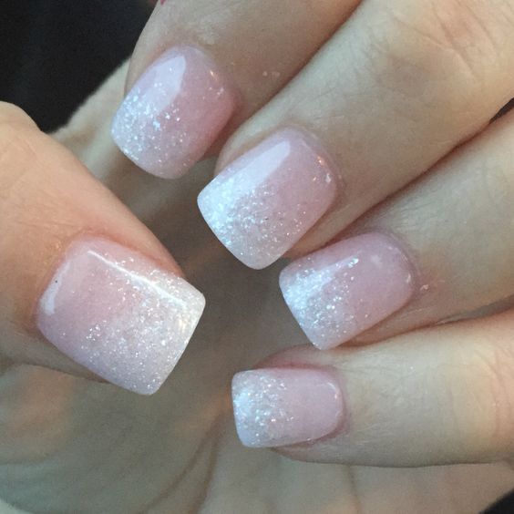 Ethereal Soft Ombre Nails with Delicate Pink Hues and Subtle Glitter.