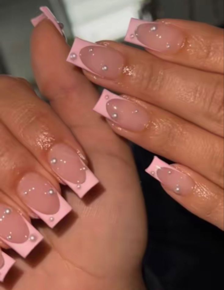 Chic Playful Nail Design with Soft Pink, Clear Accents, and Pearl Embellishments