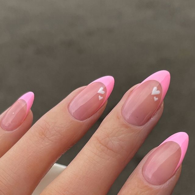 Chic Almond-Shaped Nails with Pink Tips and Heart Accents: Elegant Whimsy for Any Occasion.