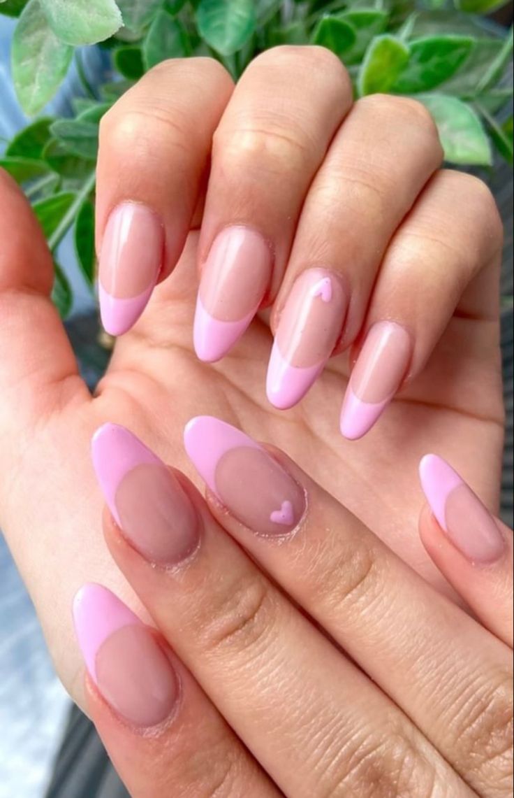 Chic Nail Design: Elegant Pink French Tips with Whimsical Heart Accents.