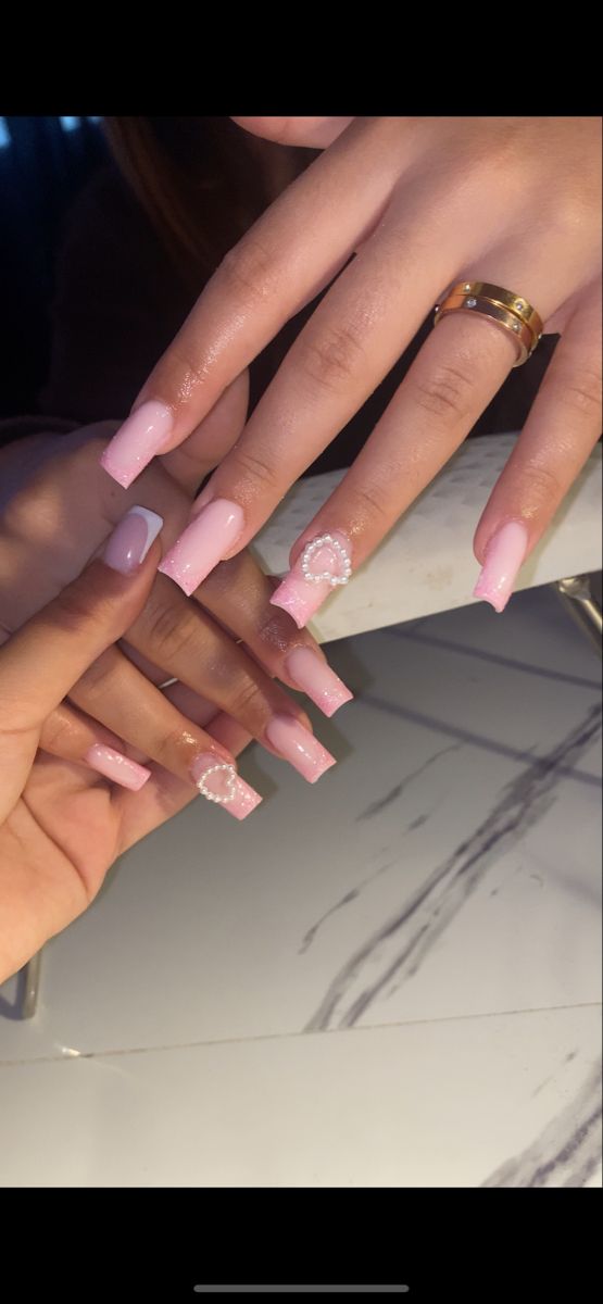 Elegant Pink Square Nails with Chic Heart Pearl Detail and Minimalist Beige Accent.