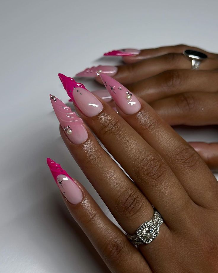 Modern Elegant Stiletto Nail Design: Soft and Vibrant Pink with Silver Accents.