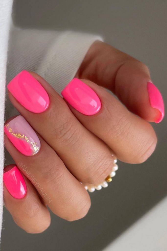 Chic Vibrant Pink Nail Design with Glossy Finishes and Artistic Gold Foil Accents.