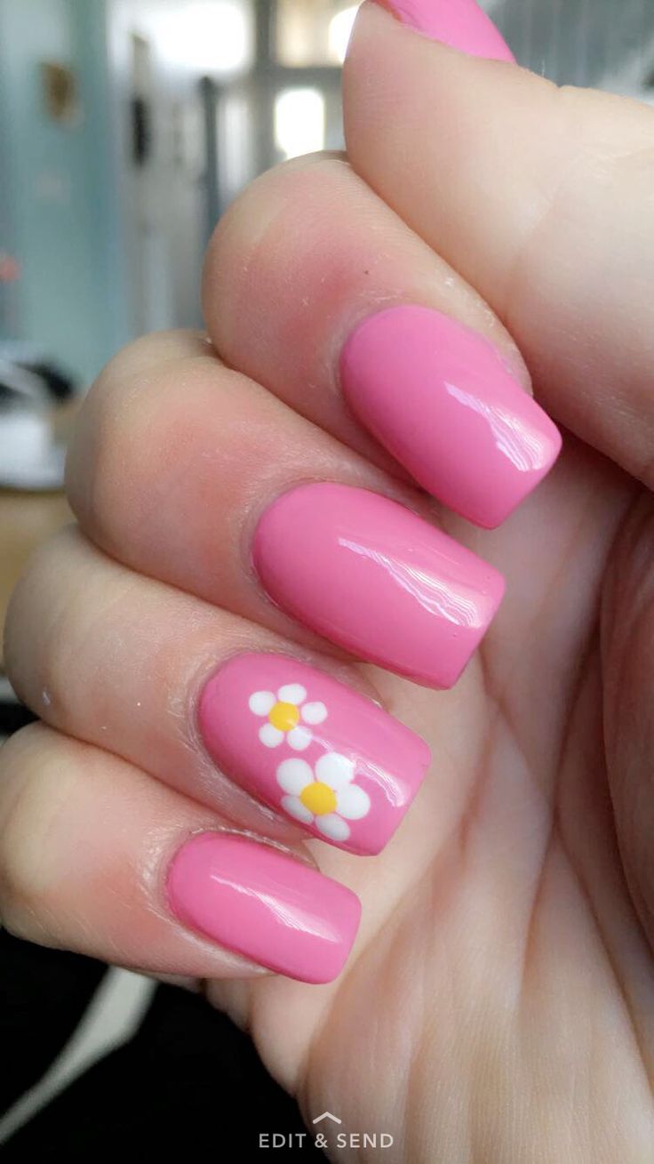 Cheerful Glossy Pink Nails with Floral Accents for a Playful Spring Aesthetic