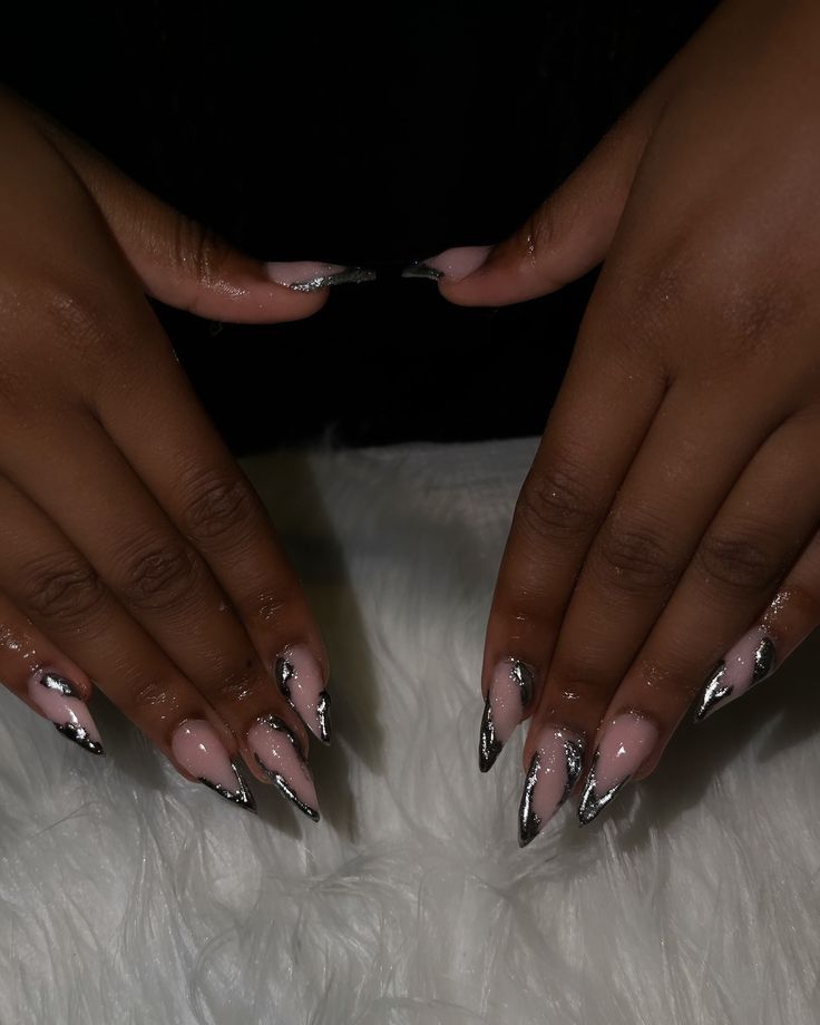 Sophisticated Stiletto Nail Design: Soft Pink Base with Bold Silver Tips