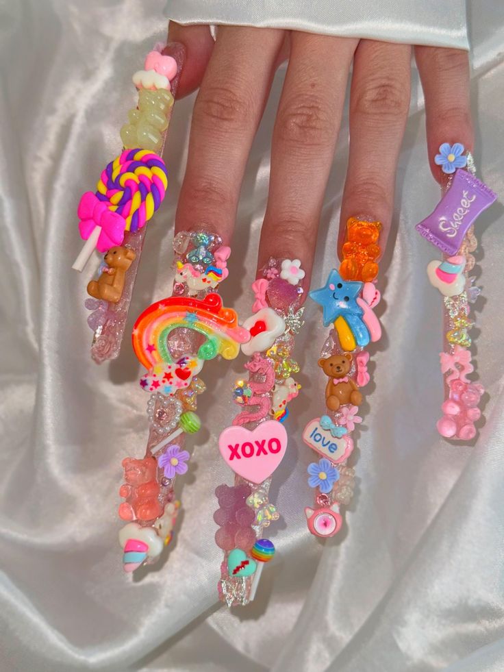 Whimsical Bold Nail Design with Colorful Embellishments and Playful Themes.