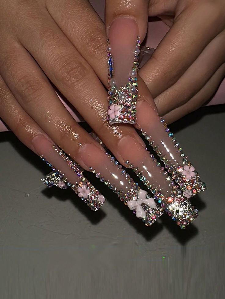 Elegant Rhinestone-Studded Nail Design with Floral Accents for a Luxurious Look.