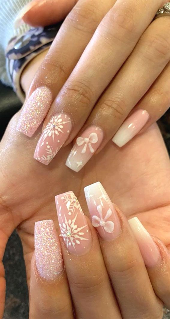 Elegant Soft Pink Nail Design with Glitter, Snowflakes, and Bows