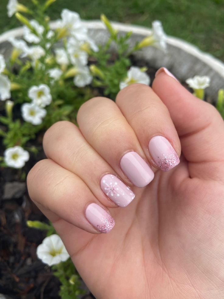 Elegant Pink Ombre Glitter Nails with Playful Accent for Spring/Summer.