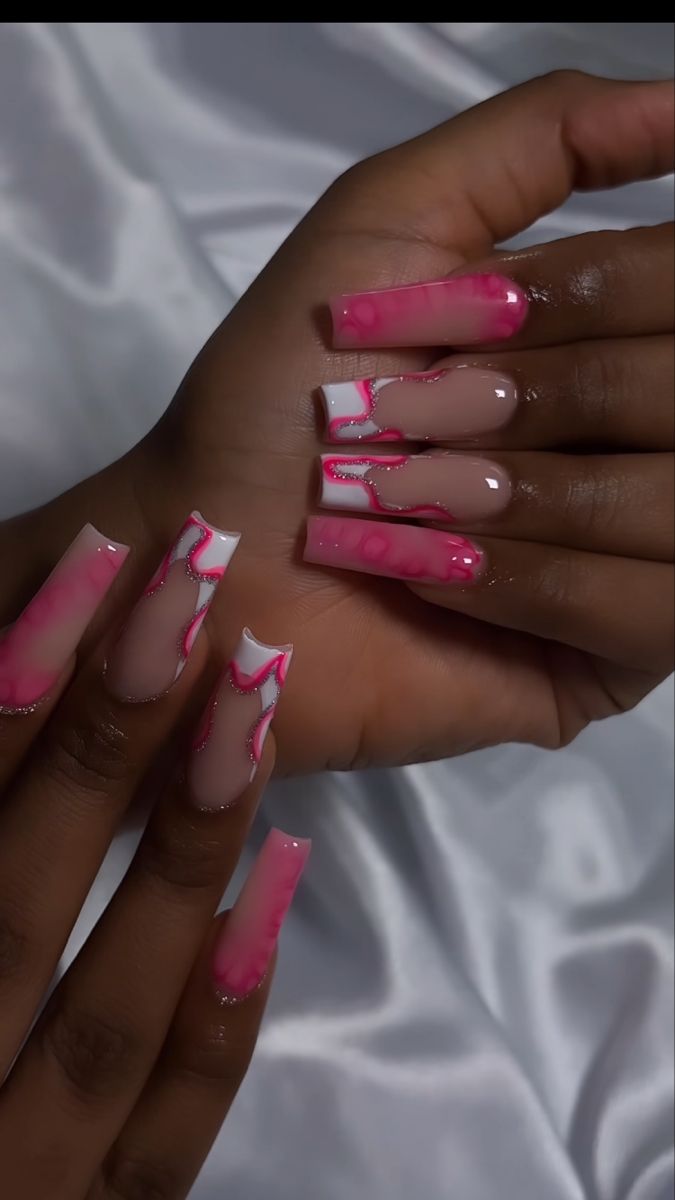 Trendy Pink and Nude Ombre Nail Art with Abstract Patterns and Glossy Finish.