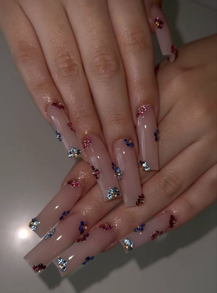 Chic Nail Design: Long Nude Nails with Colorful Rhinestone Accents