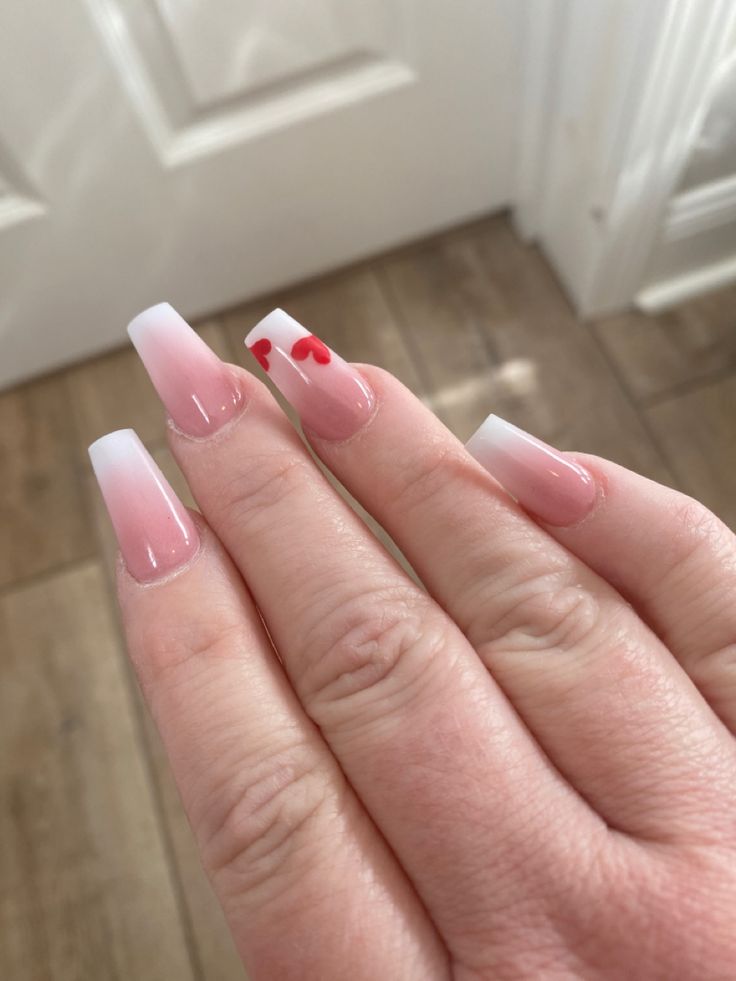 Chic Ombre Pink Manicure with Romantic Red Heart Accents.