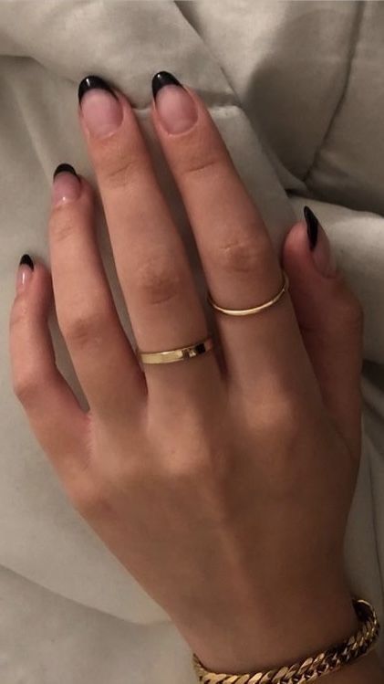 Sophisticated Black French Tip Nail Design Enhanced by Elegant Gold Rings.