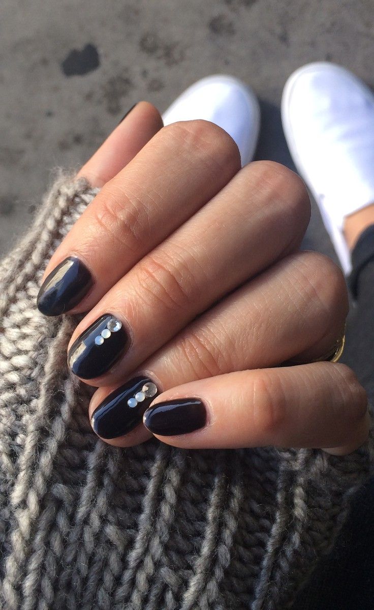 Chic Deep Navy Blue Nail Design with Delicate Gems and Glossy Finish.