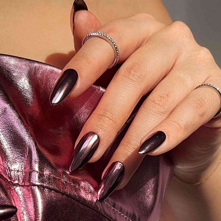 Sophisticated Almond-Shaped Black Gradient Nails with Metallic Sheen and Delicate Ring Accents.