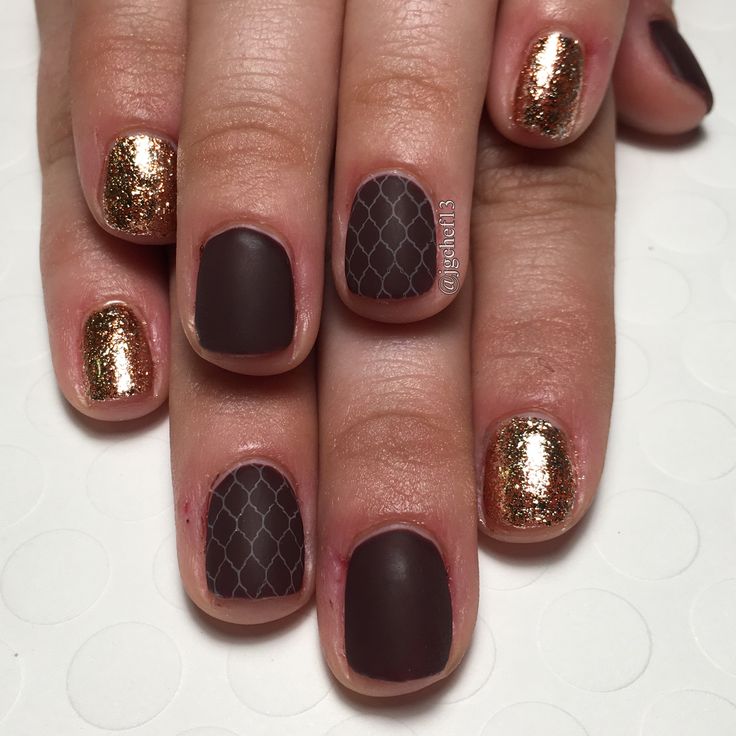 Sophisticated Brown Matte Nail Design with Geometric Pattern and Glittering Gold Accents.