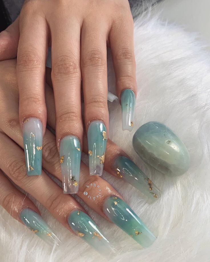 Elegant Ombre Nail Design: Serene Teal and Light Purple Gradient with Gold Accents.