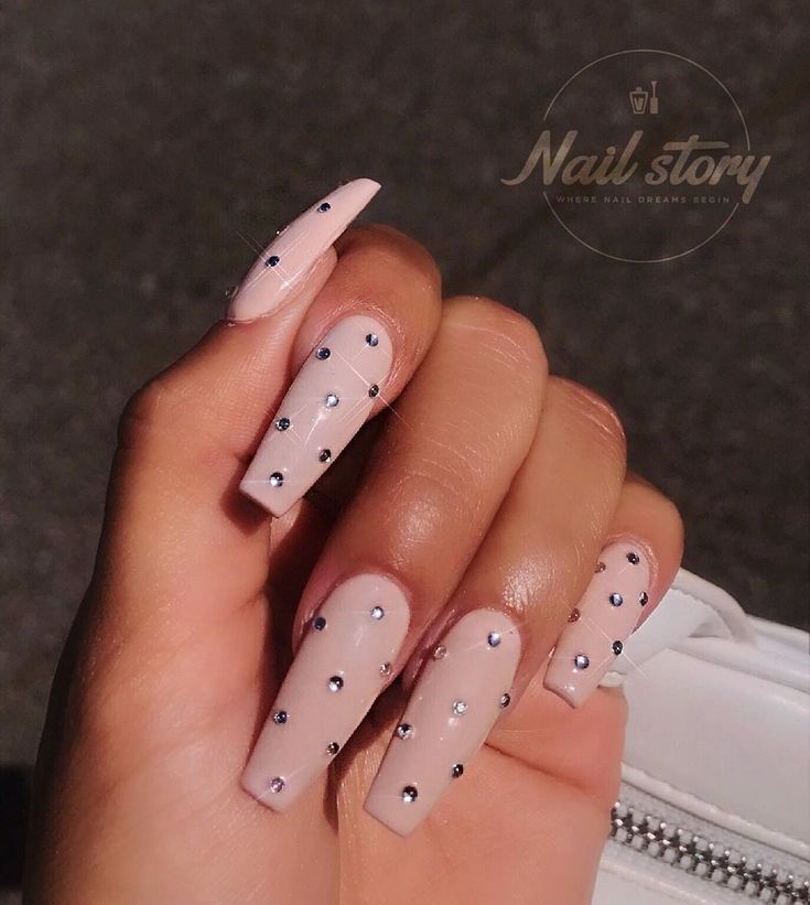 Chic Nude Nail Design with Glossy Finish and Sparkling Rhinestone Accents.