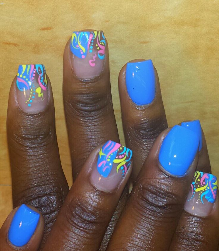 Vibrant Blue Nail Design with Playful Multicolored Patterns and Intricate Tips.