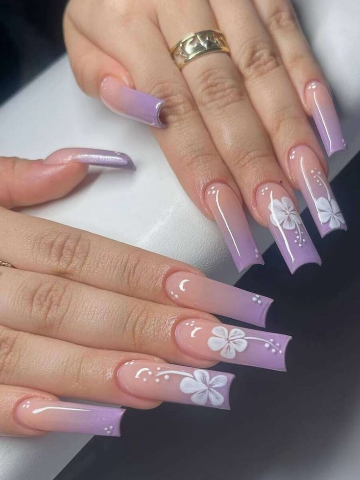 Elegant Lavender to Purple Gradient Nail Design with Floral Patterns and Glossy Finish