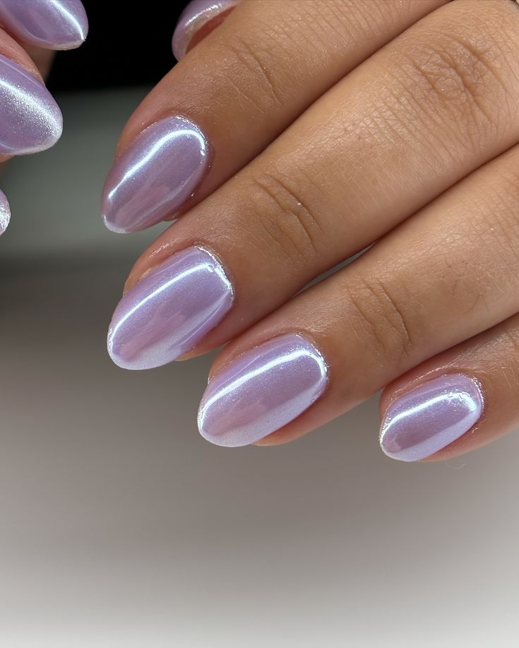 Elegant Sparkling Lilac Nail Design with Iridescent Finish and Sophisticated Almond Shape.