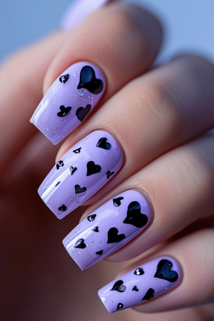 Whimsical Lavender Nail Design with Glossy Finish and Black Heart Accents.