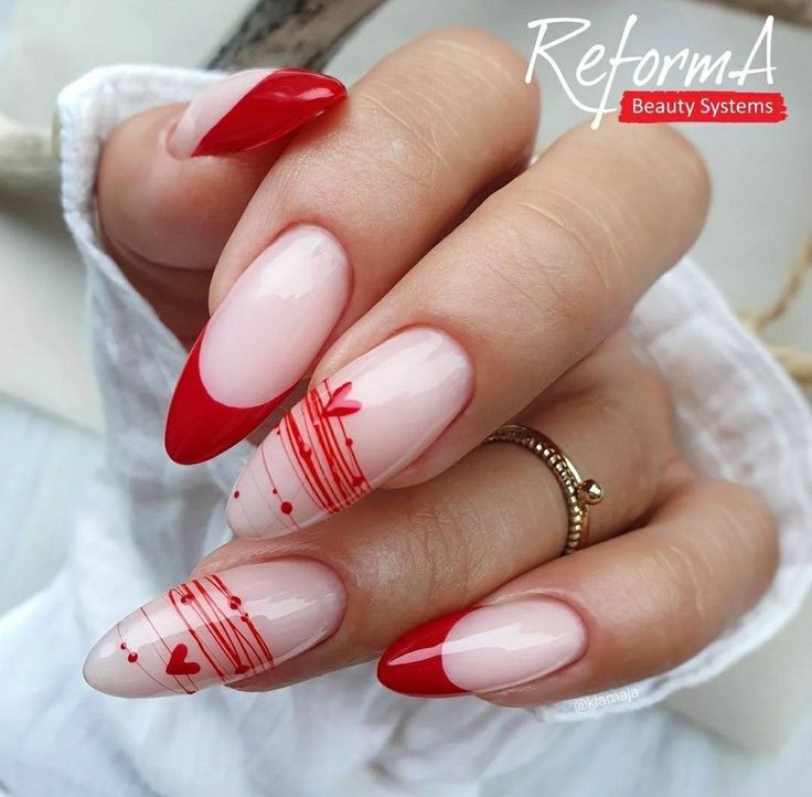 Romantic Almond-Shaped Nail Design: Red Tips and Sheer Pink Bases with Delicate Hearts.