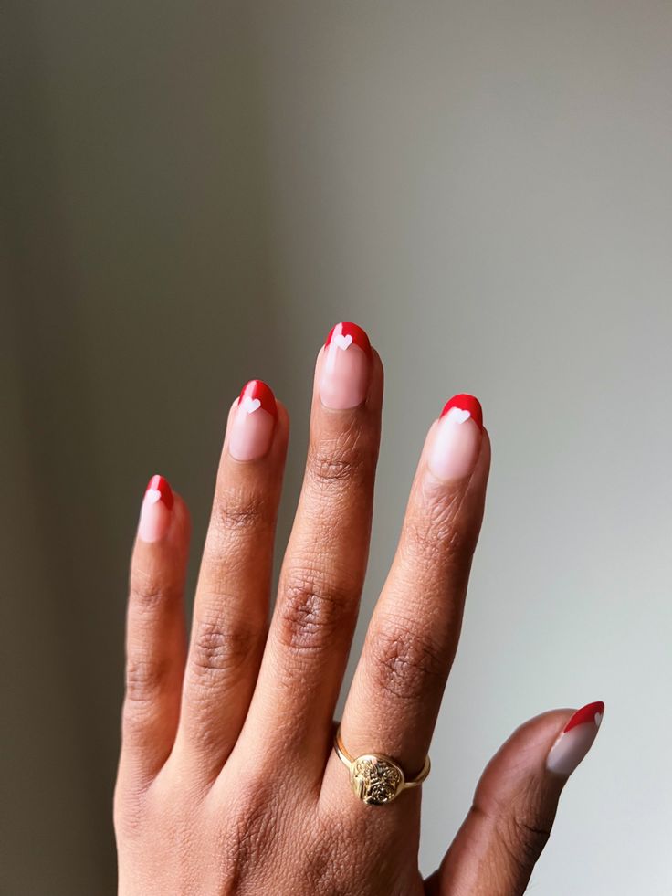 Playful Heart-Embellished French Tips with Striking Nude and Red Contrast.