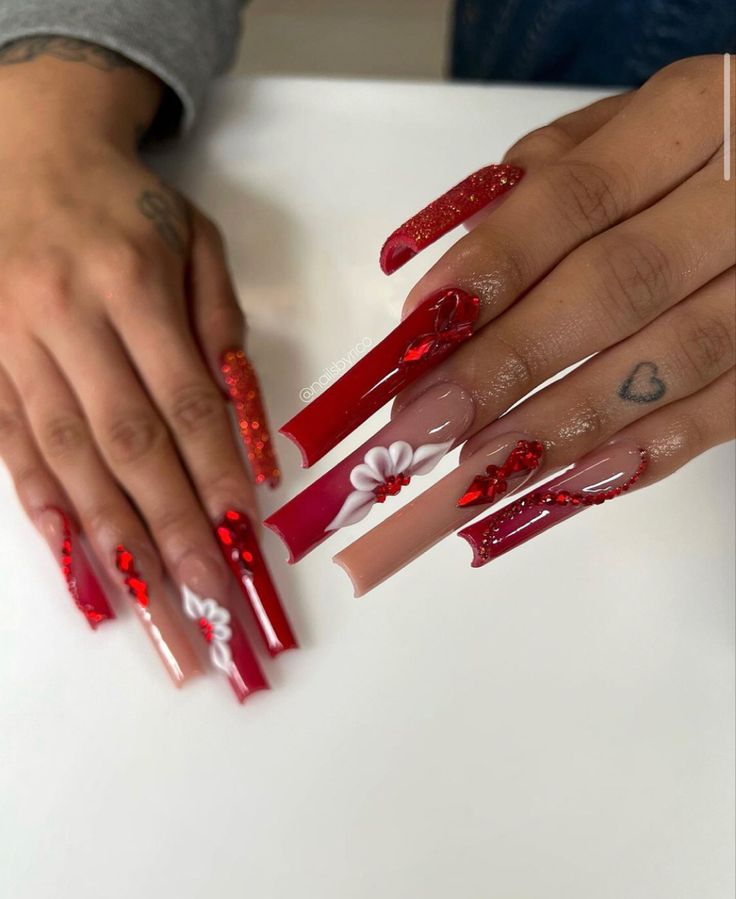 Bold and Sophisticated Red and Nude Floral Nail Design with Sparkles