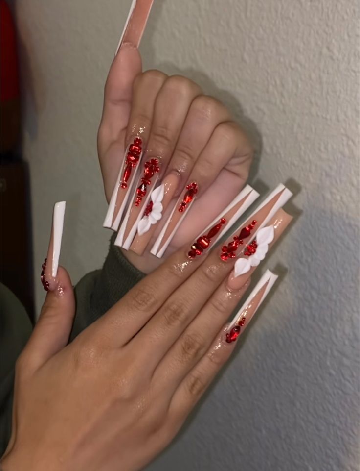 Bold and Feminine Red and White Square Nail Design with Floral Embellishments and Gemstones.