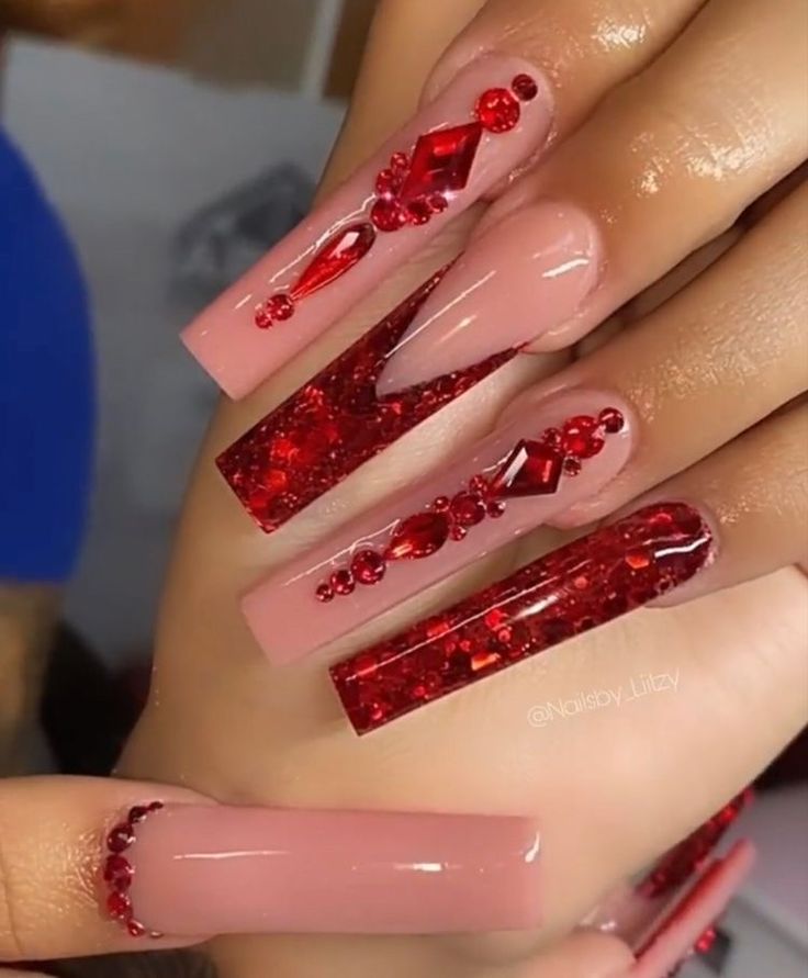 Elegant Nail Design: Luxurious Nude and Bold Red with Intricate Embellishments