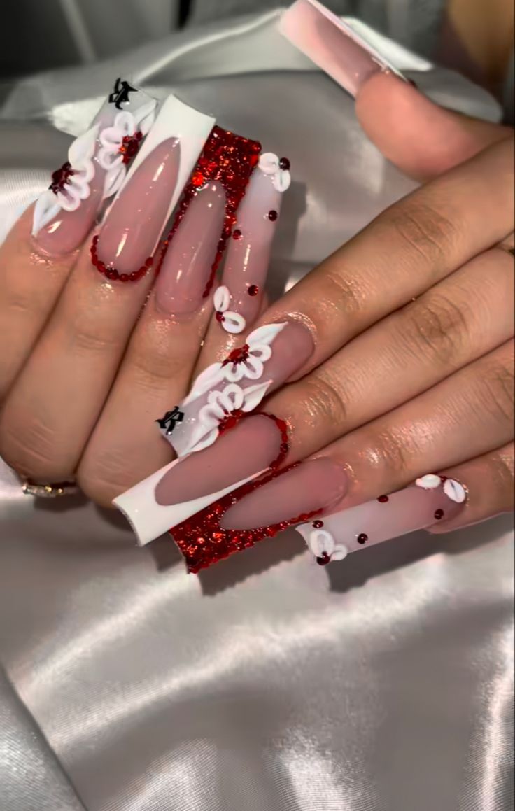 Festive Elegant Nail Design: Glossy Nude Meets Striking Red with Floral and Glitter Accents.