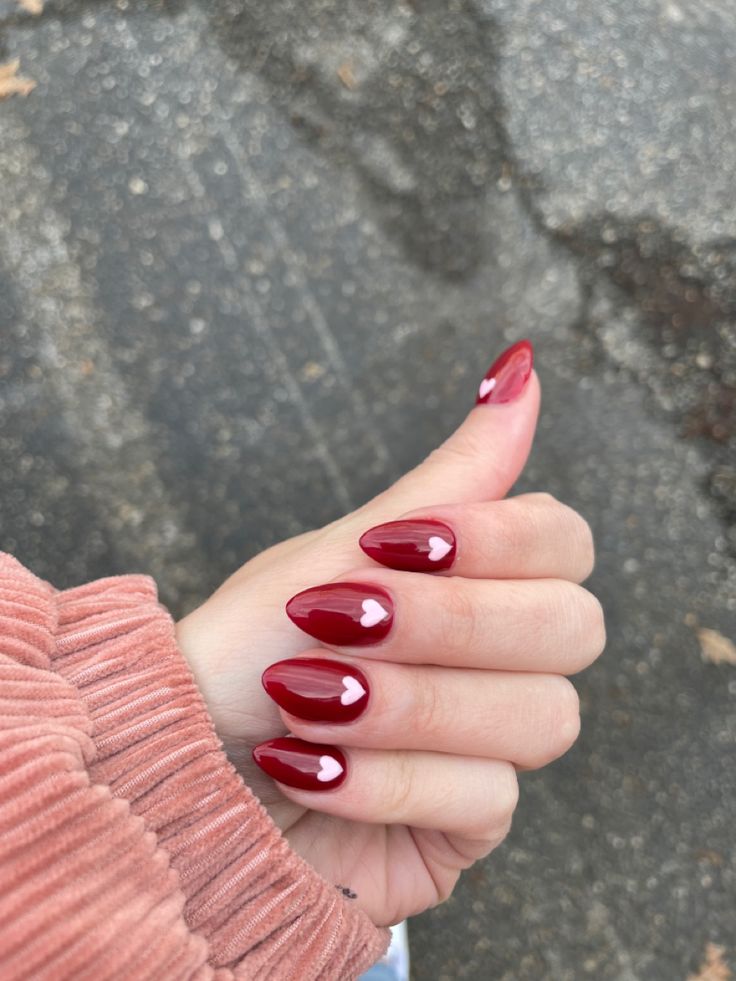 Romantic Glossy Red Almond Nails with Heart Design: A Statement Manicure.