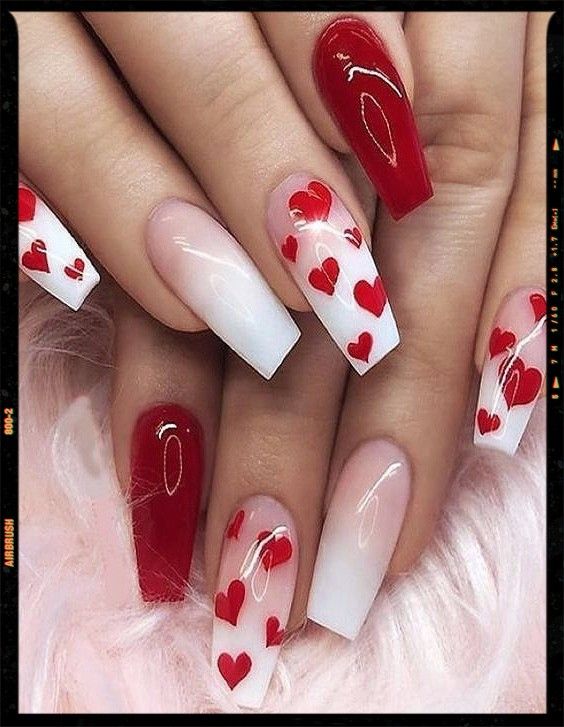 Chic Red and White Gradient Nail Design with Playful Heart Motifs.