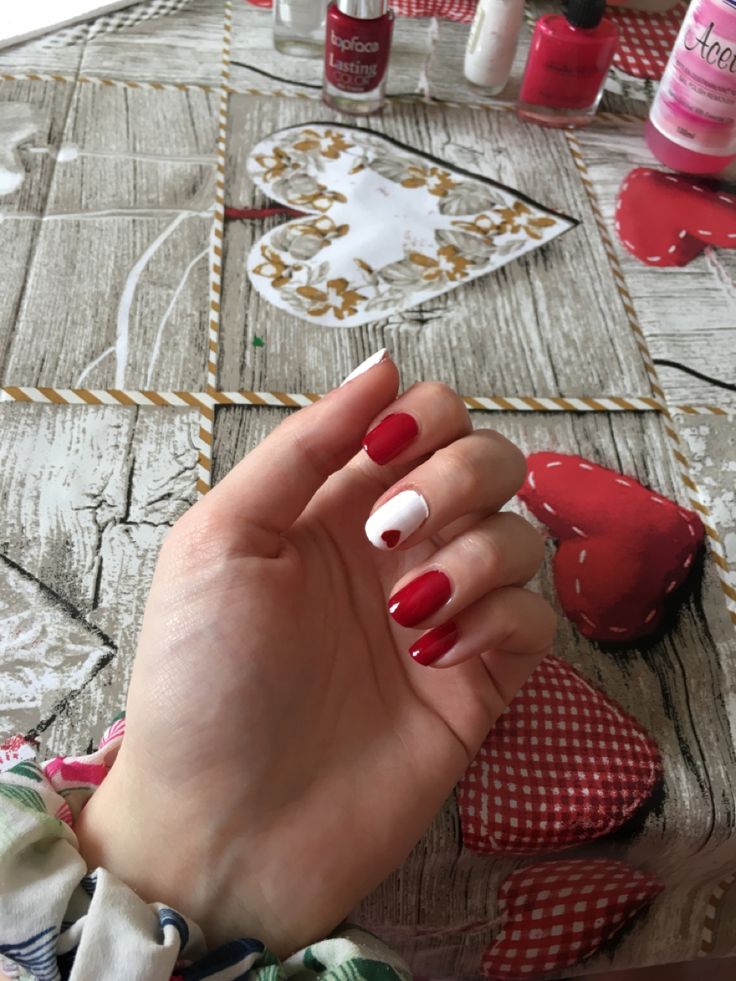 Playful Red and White Nail Design with Whimsical Heart Accent