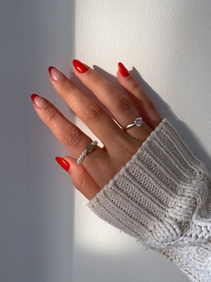 Chic Red and Nude Nail Design Accented by Dainty Rings and a Cozy Sweater.