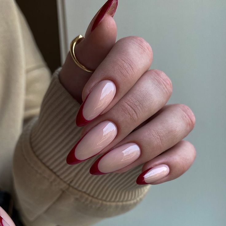 Chic Almond-Shaped Nails: Elegant Nude Base with Deep Red Tips and Glossy Finish