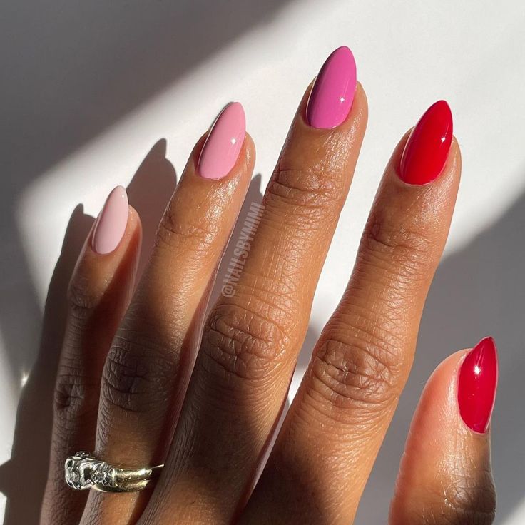 Chic Vibrant Nail Design: Elegant Blend of Soft Pink, Bold Fuchsia, and Striking Red in Oval Shapes.