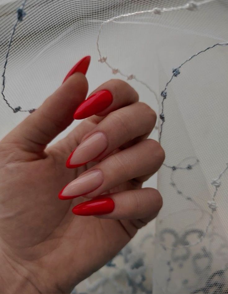 Elegant Almond-Shaped Nail Design: Striking Red and Nude Contrast with Glossy Finish.