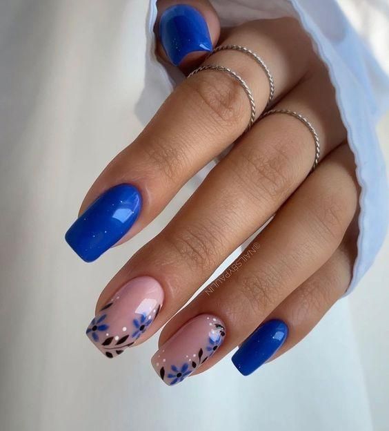 Elegant Nail Design: Bold Blue and Delicate Floral Pink Combination