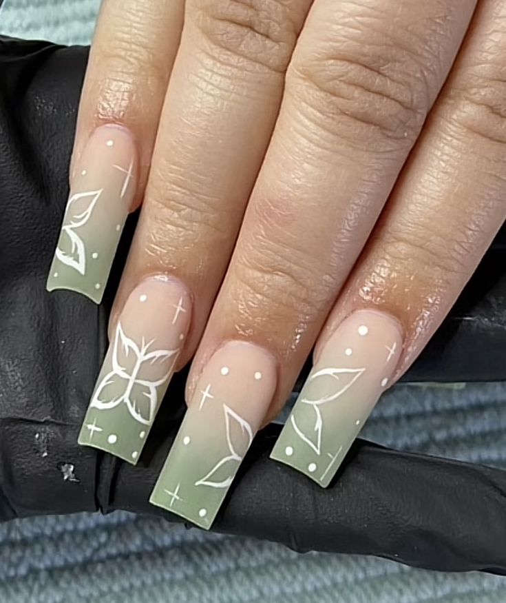 Elegant Gradient Nail Design with Floral Patterns and Matte Finish