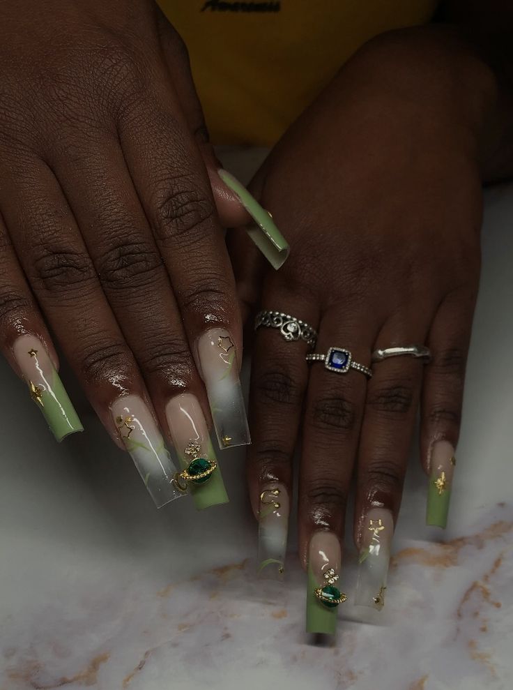 Chic Soft Green and Nude Gradient Nail Design with Luxurious Gold Detailing.