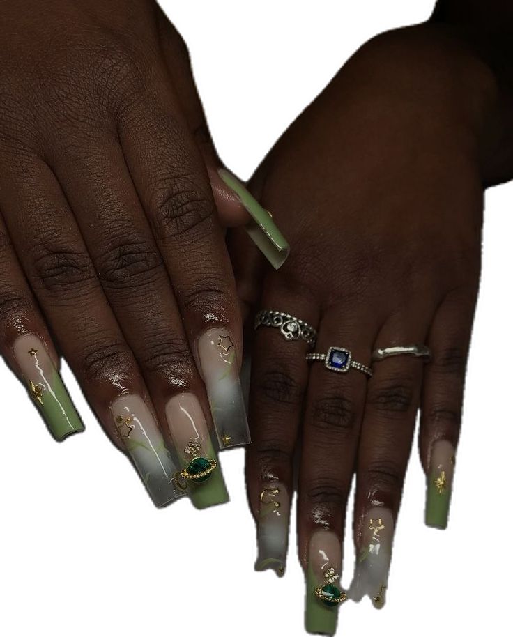 Elegant Gradient Nail Design with Gold Detailing and Gem Accents.